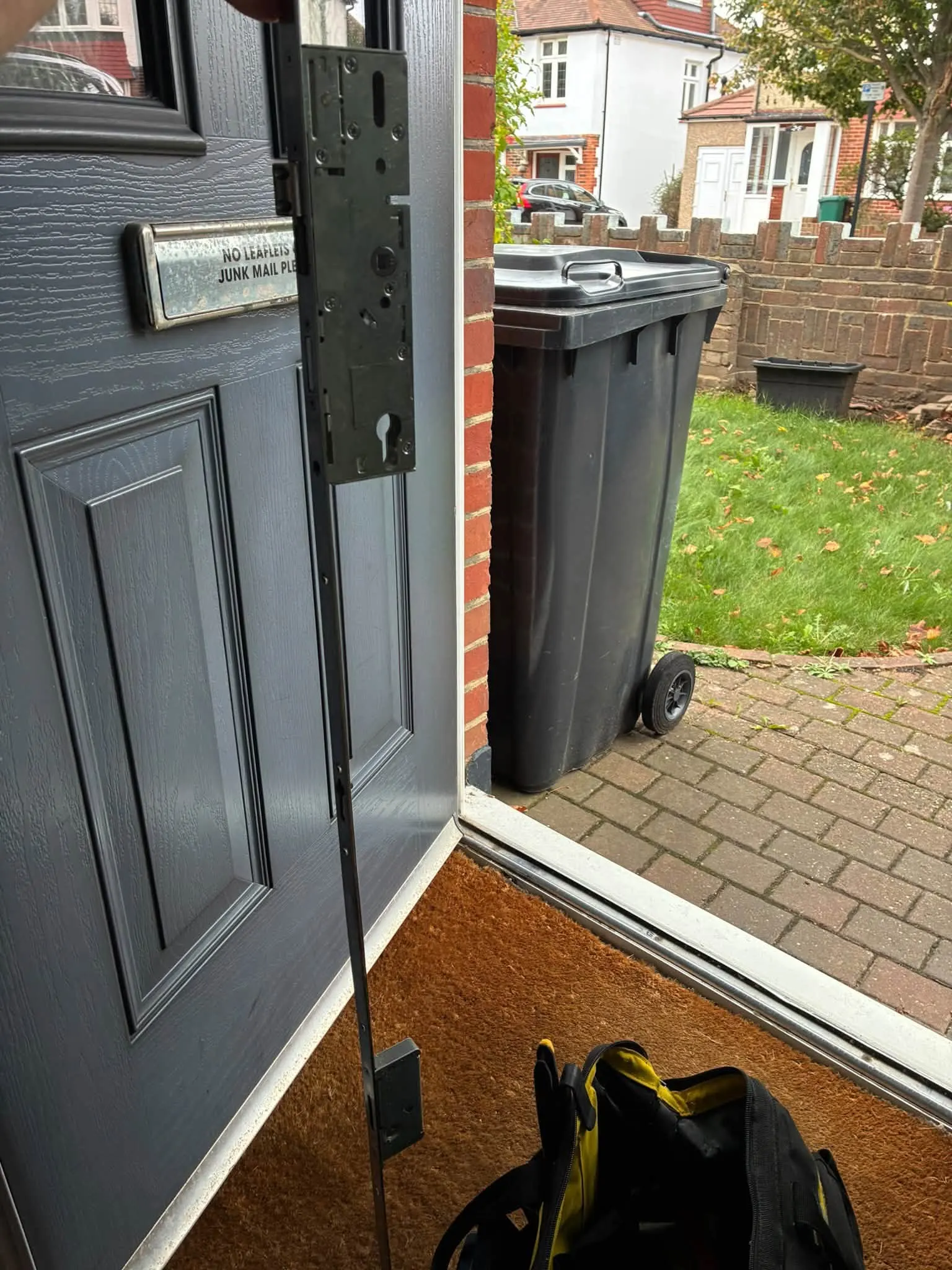 Full-length multipoint locking strip held against an open front door threshold during repair work in Hellingly.